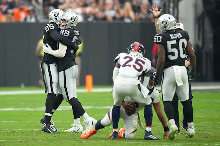 Las Vegas Raiders defensive end Maxx Crosby (98) celebrates with Las Vegas Raiders defensive end Chandler Jones (55) after sacking Denver Broncos quarterback Russell Wilson (3) during a game at Allegiant Stadium.